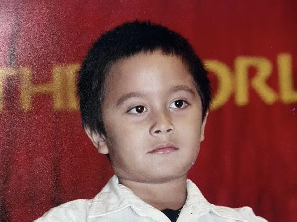 Cole as a child in a white shirt