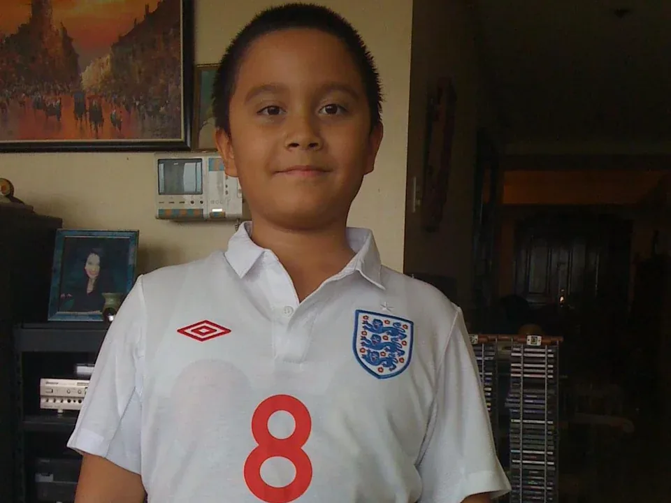Cole as a boy in a football shirt with the number 8