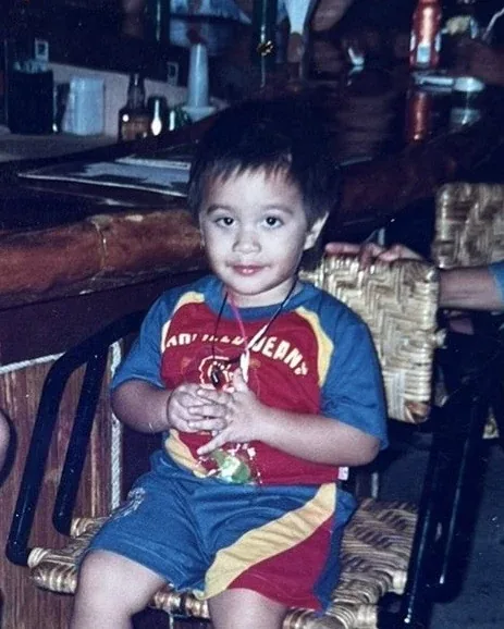 Cole as a child: on a woven chair