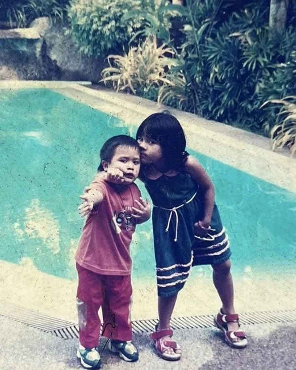 Cole as a child: by the pool with my sister